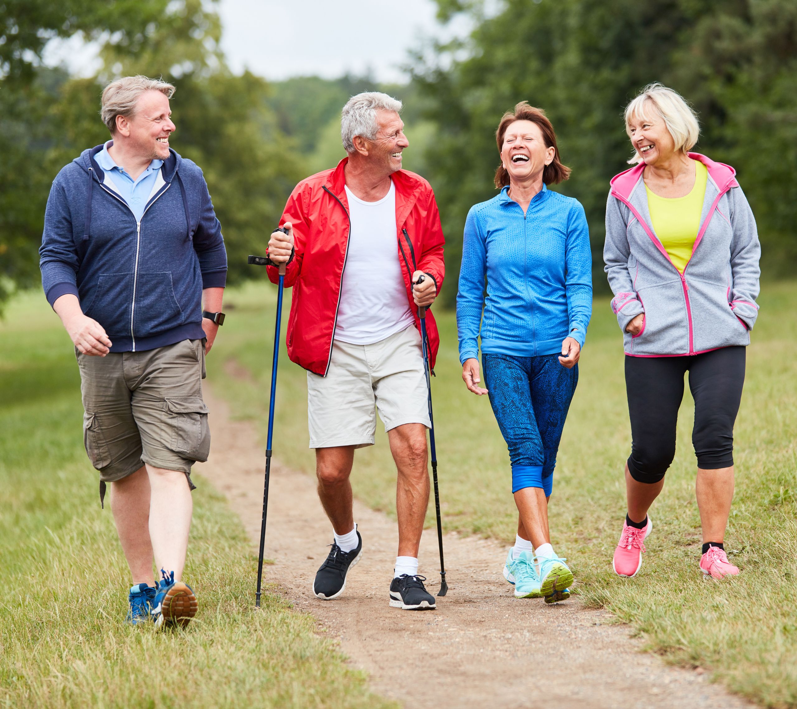 A group of friends hiking together on a trail and laughing